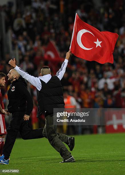 Pitch invader runs during an international friendly match between Denmark and Turkey at TREFOR Park in Odense, Denmark on September 3, 2014.