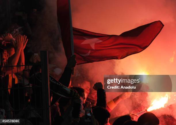 Turkish fans light up torches during an international friendly match between Denmark and Turkey at TREFOR Park in Odense, Denmark on September 3,...