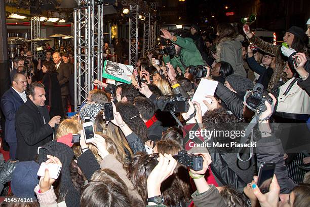 Actor Jean Dujardin signs autographs as he attends the 'The Wolf of Wall Street' Paris Premiere at Cinema Gaumont Opera on December 9, 2013 in Paris,...