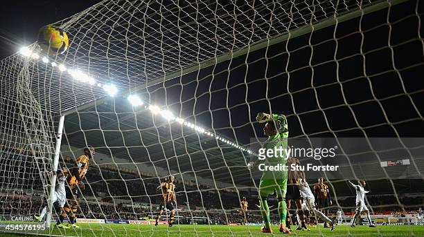 Swansea player Chico Flores scores the first Swansea goal past Hull goalkeeper Aallan McGregor during the Barclays Premier league match between...
