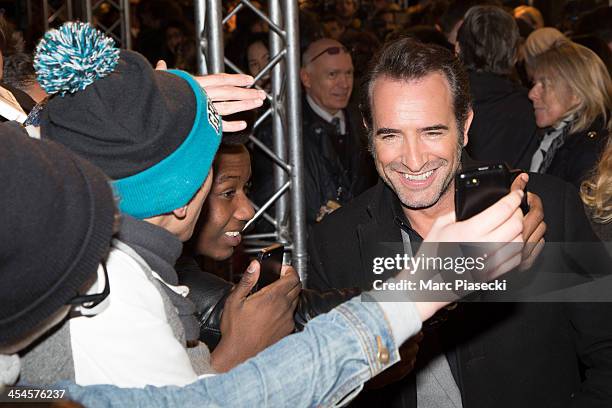 Actor Jean Dujardin poses with fans as he attends the 'The Wolf of Wall Street' Paris Premiere at Cinema Gaumont Opera on December 9, 2013 in Paris,...