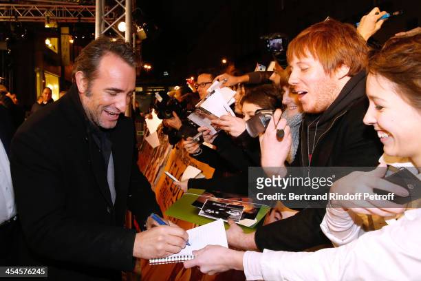 Actor Jean Dujardin signs autographs whyle arriving at the 'The Wolf of Wall Street' World movie Premiere at Cinema Gaumont Opera on December 9, 2013...