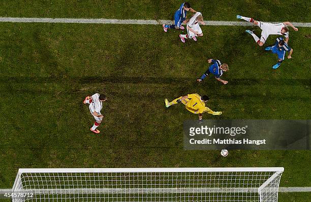 September 03: Andre Schuerrle of Germany scores his team's first goal against goalkeeper Sergio Romero of Argentina during the international friendly...