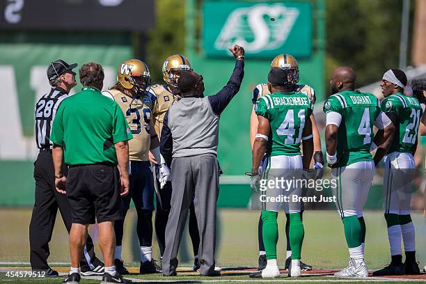 Saskatchewan Roughrider great George Reed tosses the coin for the Labour Day Classic game between the Winnipeg Blue Bombers and Saskatchewan...
