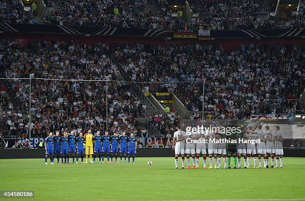 September 03: The players stand still for a minute of silence prior to the international friendly match between Germany and Argentina at Esprit-Arena...