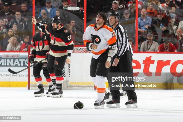 Matt Kassian of the Ottawa Senators gestures to pump up the fans after a fight with Jay Rosehill of the Philadelphia Flyers at Canadian Tire Centre...