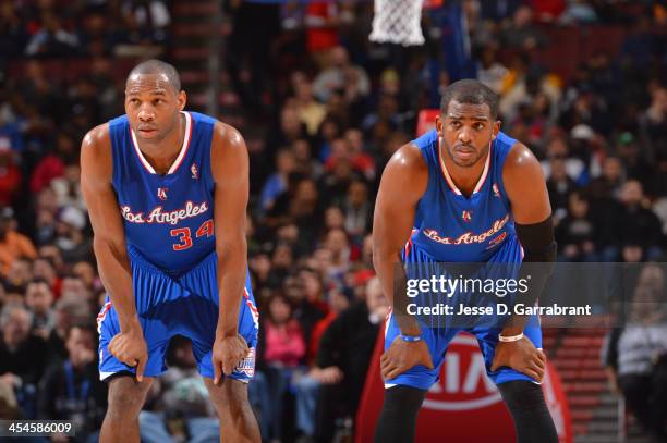 Willie Green and Chris Paul of the Los Angeles Clippers look on against the Philadelphia 76ers at the Wells Fargo Center on December 9, 2013 in...