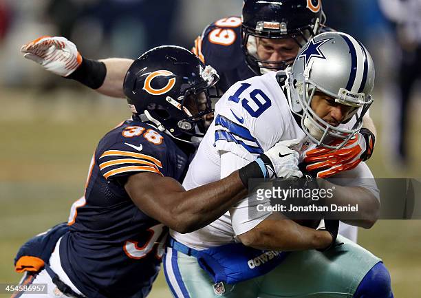Wide receiver Miles Austin of the Dallas Cowboys is tackled by cornerback Zack Bowman and defensive end Shea McClellin of the Chicago Bears during a...