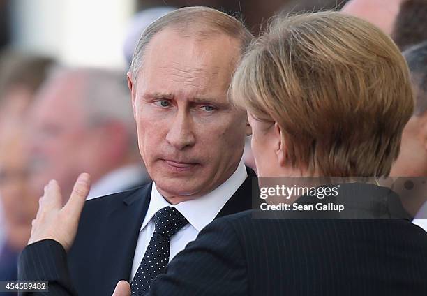 In this file photo German Chancellor Angela Merkel and Russian President Vladimir Putin attend commeoration ceremonies marking the 70th anniversary...