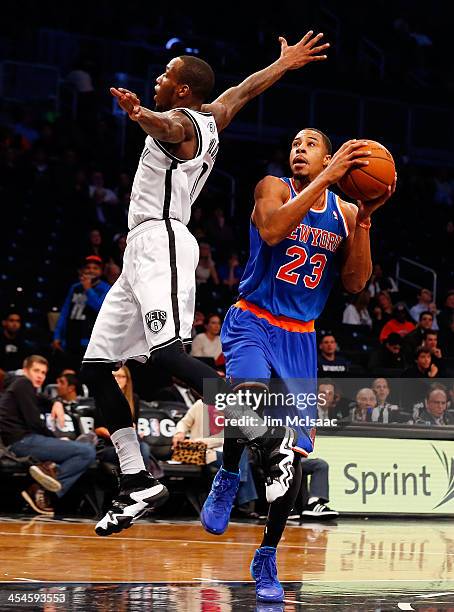 Toure' Murry of the New York Knicks in action against Tyshawn Taylor of the Brooklyn Nets at Barclays Center on December 5, 2013 in the Brooklyn...
