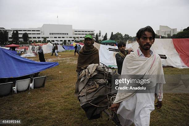 Some Pakistani anti-government protestors leave from the parliament garden upon calling of Tahir-ul-Qadri, leader of Pakistan Awami Tehreek within...