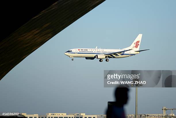 This picture taken on September 3, 2014 shows an Air China Boeing 737 preparing to land at Beijing Capital International airport. Boeing on September...