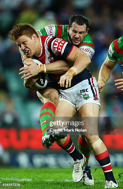 Dylan Napa of the Roosters is tackled during the round 26 NRL match between the Sydney Roosters and the South Sydney Rabbitohs at Allianz Stadium on...