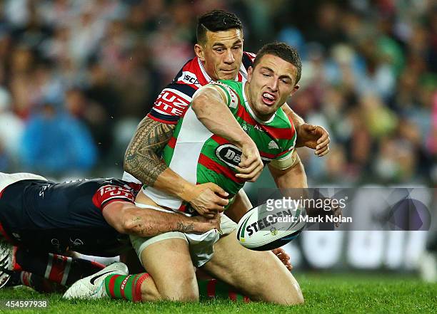 Sam Burgess of the Rabbitohs loses the ball in a tackle by Sonny Bill Williams of the Roosters during the round 26 NRL match between the Sydney...