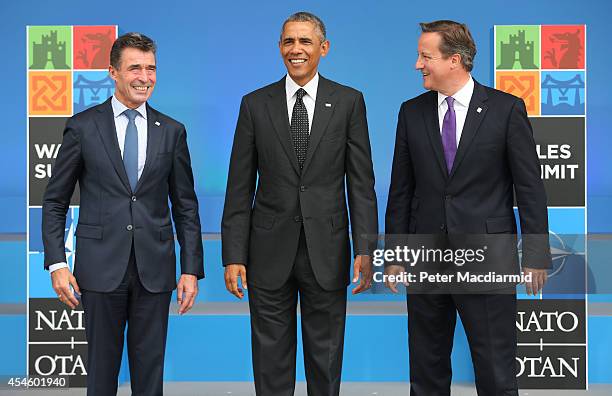 President Barack Obama stands with NATO Secretary General Anders Fogh Rasmussen and British Prime Minister David Cameron at the NATO Summit on...