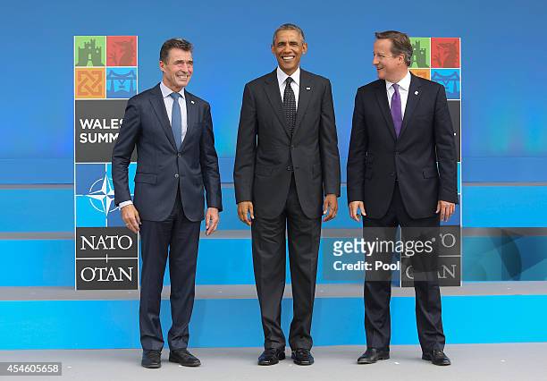 Anders Fogh Rasmussen , Secretary General of the North Atlantic Treaty Organization , stands with U.S. President Barack Obama and British Prime...