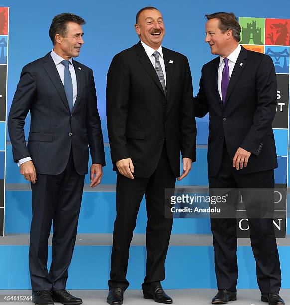 Azerbaijan's President Ilham Aliyev speaks with NATO Secretary General Anders Fogh Rasmussen and British Prime Minister David Cameron as he arrives...