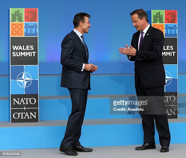 Secretary General Anders Fogh Rasmussen speaks with British Prime Minister David Cameron during the welcoming ceremony at the NATO Summit 2014 at the...