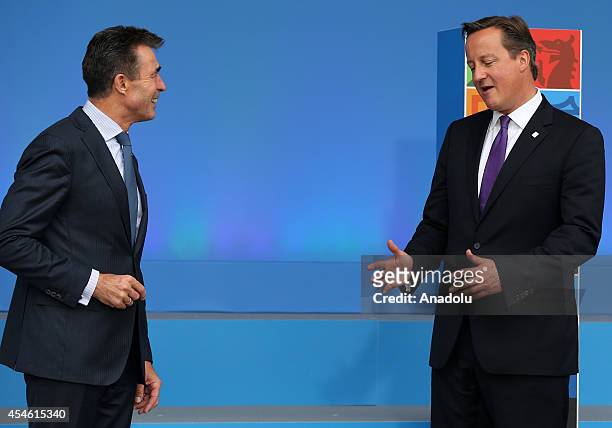 Secretary General Anders Fogh Rasmussen speaks with British Prime Minister David Cameron during the welcoming ceremony at the NATO Summit 2014 at the...
