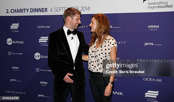 Thomas Hitzlsperger, former international football player of Germany and Katrin Bauerfeind pose during the charity dinner of the Magnus Hirschfeld...