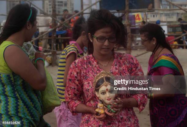 Hindu devotee taking idol of goddess Gauri for immersion at Girgoan Chowpathy on seventh day of Ganesha festival on September 4, 2014 in Mumbai,...