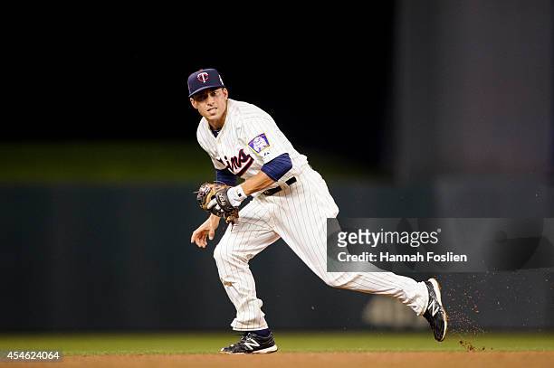 Doug Bernier of the Minnesota Twins makes a play at shortstop against the Chicago White Sox during the game on September 3, 2014 at Target Field in...