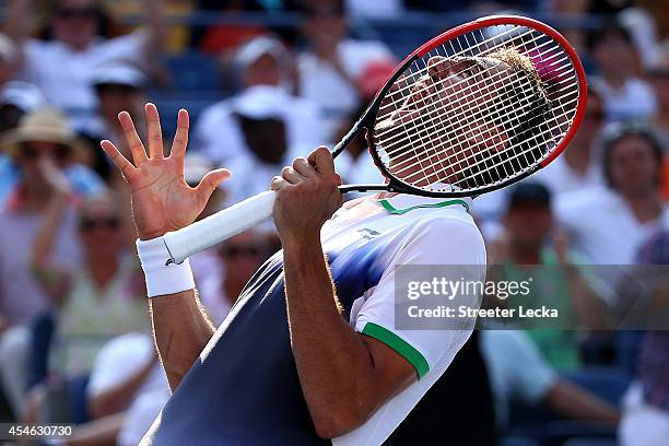 Marin Cilic of Croatia reacts after defeating Tomas Berdych of the Czech Republic during their men's singles quarterfinal match on Day Eleven of the...