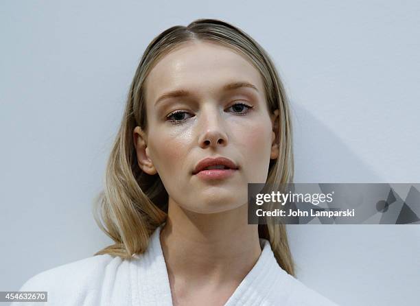 Model Regina Klerow perpares backstage at the Costello Tagliapietra during MADE Fashion Week Spring 2015 at Milk Studios on September 4, 2014 in New...