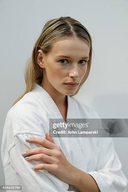 Model Regina Klerow perpares backstage at the Costello Tagliapietra during MADE Fashion Week Spring 2015 at Milk Studios on September 4, 2014 in New...