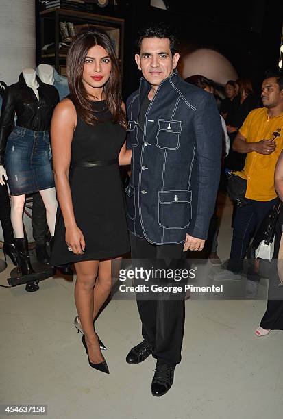 Actress Priyanka Chopra and director Omung Kumar attend the Guess Portrait Studio during the 2014 Toronto International Film Festival at TIFF Bell...