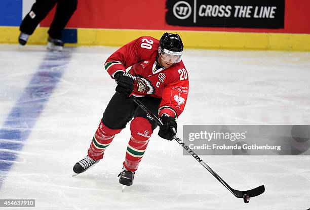 Joel Lundqvist of Frolunda moves the puck during the Champions Hockey League group stage game against Geneve-Servette on September 4, 2014 in...