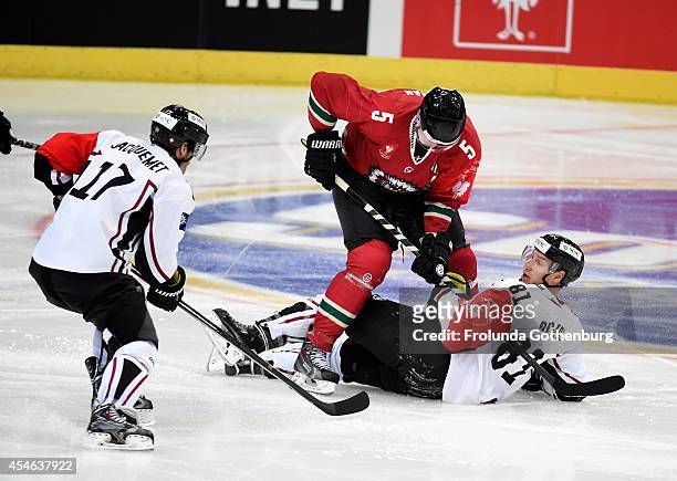 Christian Backman of Frolunda battles Alexandre Picard and Arnaud Jacquemet of Geneve-Servette during the Champions Hockey League group stage game...