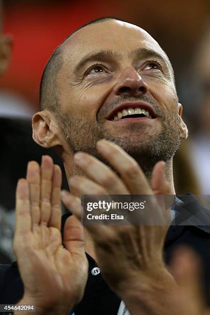 Actor Hugh Jackman attends Roger Federer of Switzerland play against Gael Monfils of France during their men's singles quarterfinal match on Day...