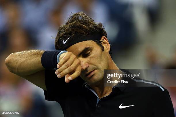 Roger Federer of Switzerland looks on against Gael Monfils of France during their men's singles quarterfinal match on Day Eleven of the 2014 US Open...