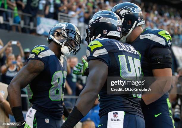 Wide Receiver Ricardo Lockette of the Seattle Seahawks celebrates with teammates after scoring a touchdown during the second quarter of the game...