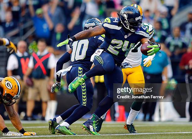 Running Back Marshawn Lynch of the Seattle Seahawks scores a touchdown during the second quarter of the game against the Green Bay Packers at...