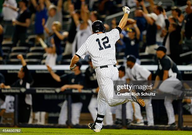 Chase Headley of the New York Yankees celebrates after hitting a walk off home run in the ninth inning to defeat of the Boston Red Sox 5-4 during a...