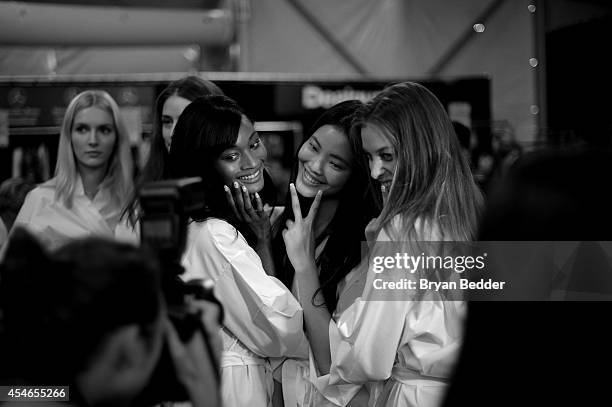 Models prepare backstage at Mercedes-Benz Fashion Week Fall 2014 on September 4, 2014 in New York City.