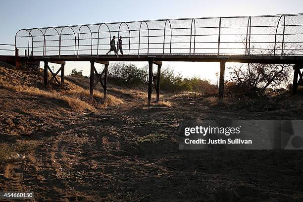 Footbridge spans a completely dry river bed on September 4, 2014 in Porterville, California. Over 300 homes in the California central valley city of...