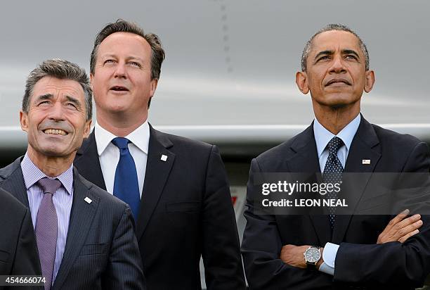 Secretary General Anders Fogh Rasmussen , Britain's Prime Minister David Cameron and US President Barack Obama watch a flypast of military aircraft...