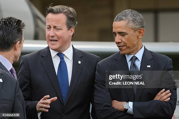 Secretary General Anders Fogh Rasmussen , Britain's Prime Minister David Cameron and US President Barack Obama talk as they prepare to watch a...