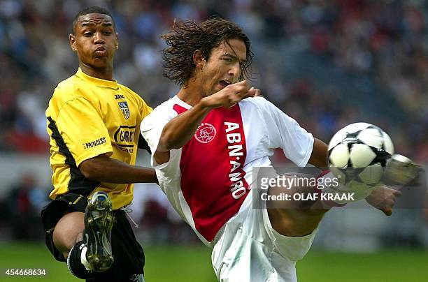 Ajax Amsterdam's forward Mido scores the equalizing 2-2 goal while being challenged by NAC Breda's Jurgen Collin during a Dutch soccer league match...