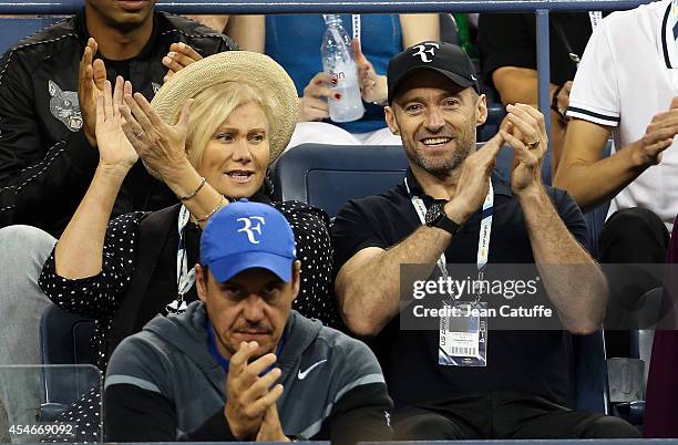 Hugh Jackman and his wife Deborra-Lee Furness attend the match between Roger Federer of Switzerland and Gael Monfils of France during Day 11 of the...