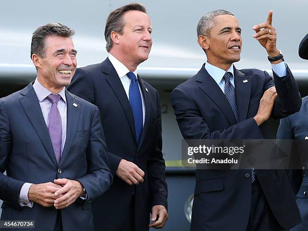 President Barack Obama , British Prime Minister David Cameron and NATO Secretary General Anders Fogh Rasmussen watch a flypast of military aircraft...