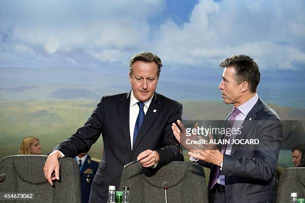 Britain's Prime Minister David Cameron , talks with Nato Secretary General Anders Fogh Rasmussen , ahead of a meeting on the second day of the NATO...