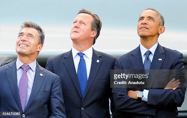 President Barack Obama , British Prime Minister David Cameron and NATO Secretary General Anders Fogh Rasmussen watch a flypast of military aircraft...