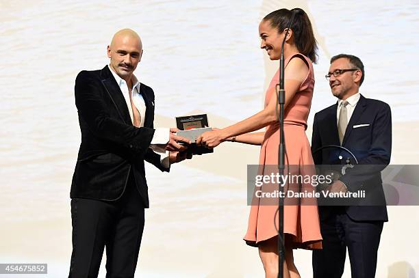 James Franco receives the Jaeger-LeCoultre Glory to the Filmmaker 2014 award from Carmen Chaplin during the 71st Venice Film Festival at Sala Grande...