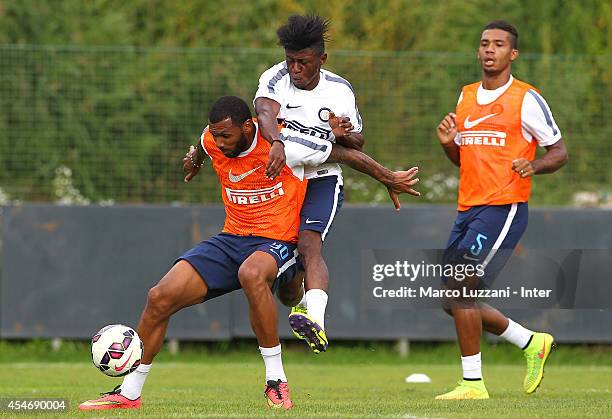 Yann M'Vila competes for the ball with Samuel Appiah during FC Internazionale training session at the club's training ground on September 5, 2014 in...