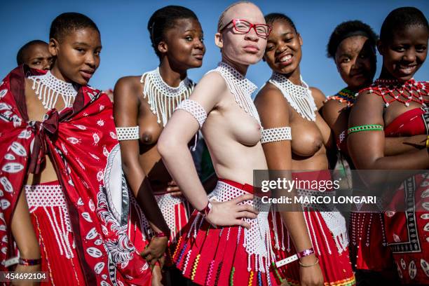 South African albino maiden poses with other maidens, bare breasted as the tradition requires, as they prepare themselves for the Reed Dance ceremony...