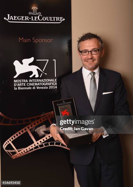 Jaeger-LeCoultre Communication Director Laurent Vinay poses with the 'Jaeger-LeCoultre Glory To The Filmmaker 2014 Award' honoring James Franco in...